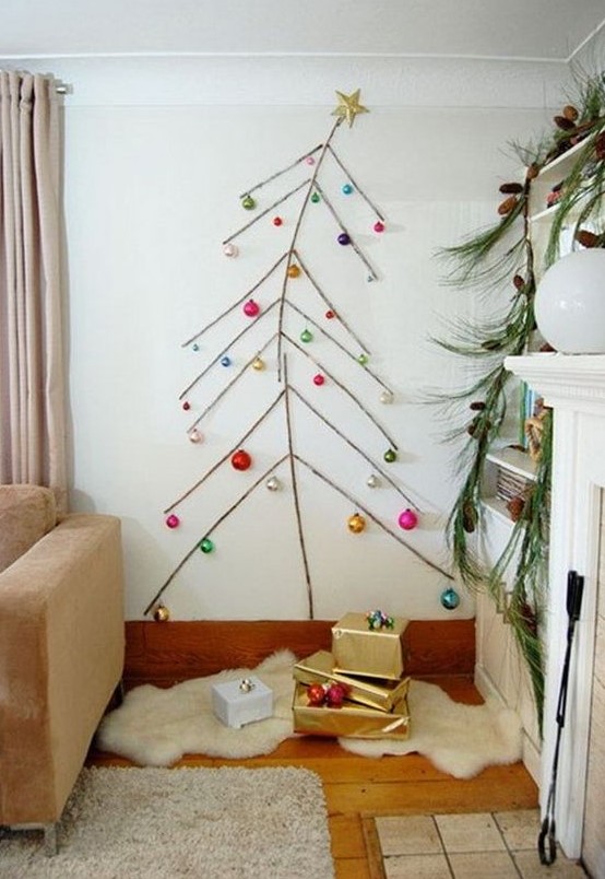 a simple wall Christmas tree done with tape and some colorful ornaments attached to the wall