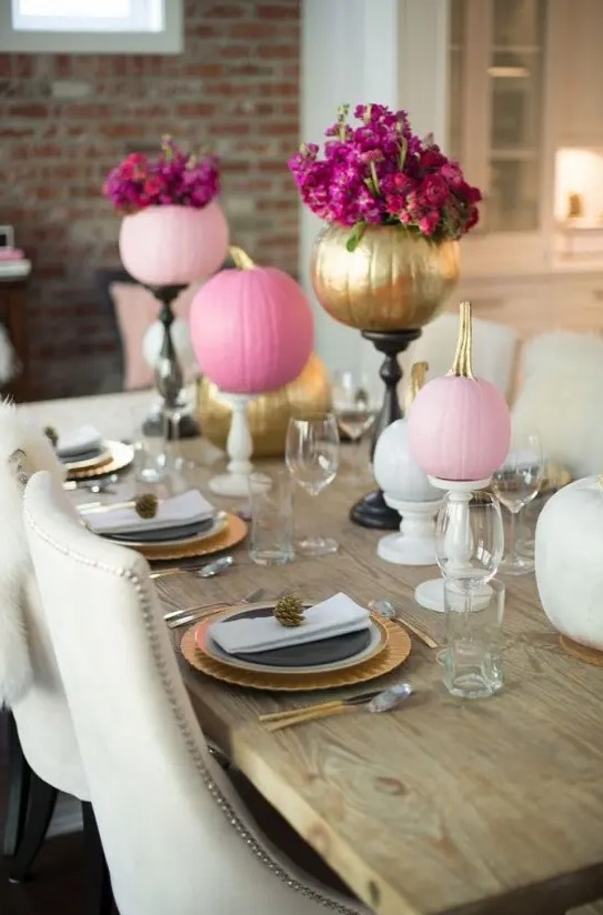 bright pink and gold pumpkins with bold blooms on stands will spruce up your Thanksgiving tablescape
