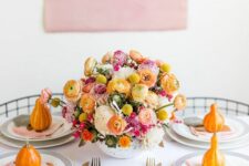 27 a modern and bright Thanksgiving tablescape with bold blooms in the center and orange pumpkins is amazing