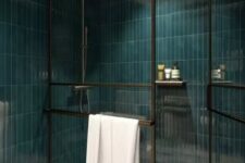 27 a shower space done with teal skinny tile, with black framed doors and a white floor is a bold and contrasting space