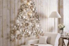 27 a subtle white Christmas tree of white ornaments and fluffs plus a star on top is realized right on the wall