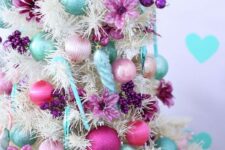 27 a white Christmas tree with blush, pink, aqua and purple ornaments, beads and purple fabric blooms is a fantastic idea
