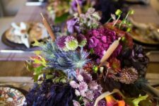 28 a refined and bold Thanksgiving centerpiece of purple, orange and fuchsia blooms, greenery, thistles and some foliage