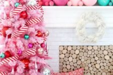 29 a pastel pink Christmas tree decorated with pink, red, green and silver ornaments and with a striped garland is pure fun and glam