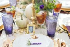 29 a refined gold and purple Thanksgiving tablescape with gold cutleyr, chargers and candlesticks, white pumpkins, greenery, purple glasses and napkins