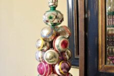 30 a bright tabletop Christmas tree of vintage ornaments, with evergreens under it is a lovely idea for a vintage celebration