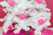 30 a white Christmas tree decorated with hot pink paper pompoms and flamingo-shaped ornaments is a fun idea for a tropical holiday space
