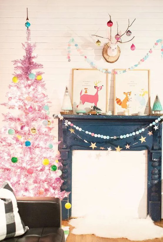 a pastel pink Christmas tree with aqua, green, yellow ornaments and lights is a dreamy and unusual idea for every space