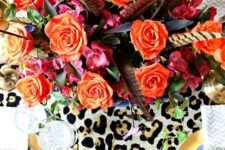 31 a super bold Thanksgiving tablescape with blue and gold plates, a leopard and hot pink table runner, orange blooms and feathers