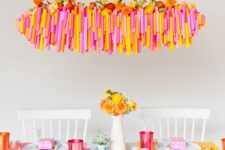 32 a super bright Thanksgiving tablescape with bold placemats, colorful glasses and blooms, a bold overhead installation with blooms