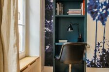 34 a tiny working nook built into a wall in the living room, with a wall mural and a teal inside, with a black chair