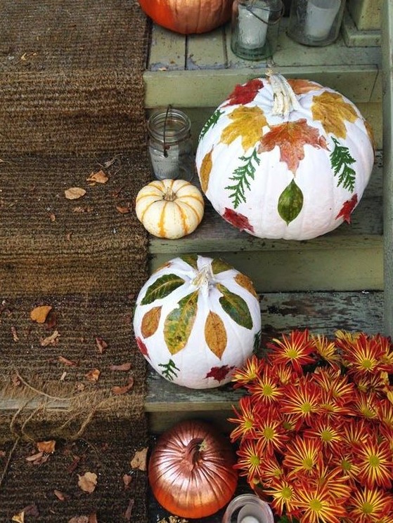 white pumpkins with fall leaf decoupage and a bronze one will decorate your steps in a stylish and chic way