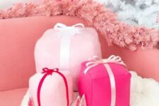 35 funky pink gift box holiday pillows, a pink fir garland and a hot pink mini Christmas tree decor glam and chic Christmas decor