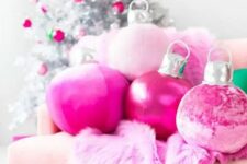 36 hot pink Christmas ornament pillows and a faux fur blanket plus matching ornaments on the silver Christmas tree