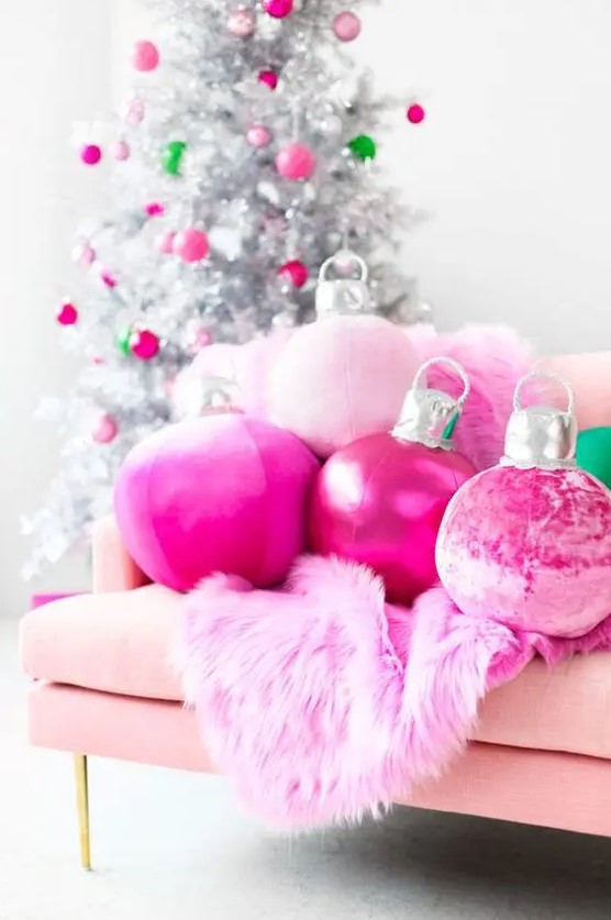 hot pink Christmas ornament pillows and a faux fur blanket plus matching ornaments on the silver Christmas tree