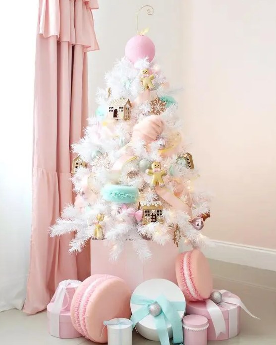 a small white Christmas tree decorated with pink, aqua, blush ornaments - houses, cookies, macarons and oversized ornaments looks amazing