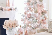 40 a white Christmas tree decorated with pastel pink, green and white ornaments, pink ribbon and pink branches on top