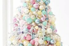 42 a white Christmas tree with pastel blue, yellow, pink, blush and other ornaments fully covering the tree and making it look fantastic
