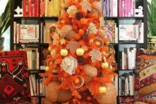 a beautiful Thanksgiving tree in orange, with pinecones, citrus, oversized acorns and ornaments is very unusual