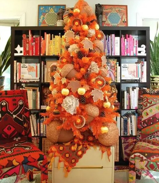 a beautiful Thanksgiving tree in orange, with pinecones, citrus, oversized acorns and ornaments is very unusual