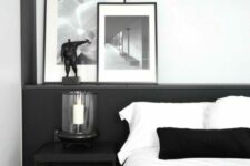 a simple b&w bedroom with a black nightstand