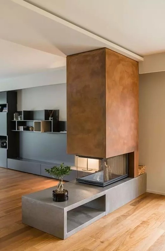 a contemporary fireplace with a concrete base, a metal hood and a glass cover looks contrasting and very bold