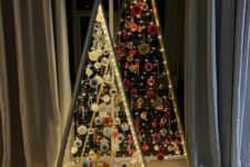 a duo of frame christmas tree with lights, white and silver and red and gold ornaments is a super creative solution for the holidays
