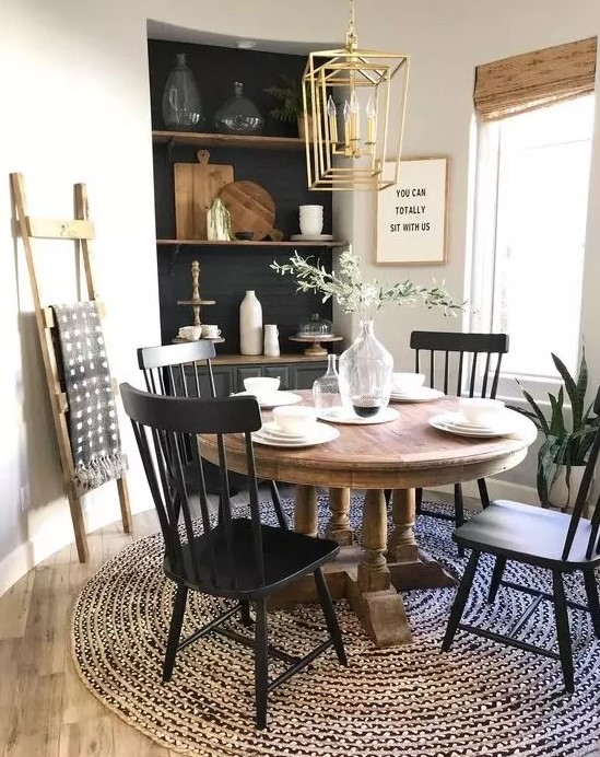 a farmhouse dining room with a vintage wooden table that sets the tone of the space and much texture