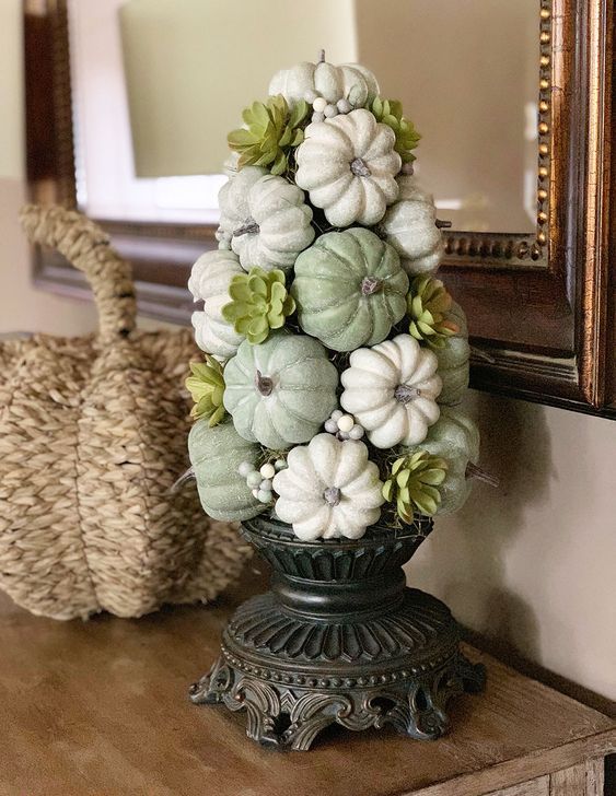 a green and white Thanksgiving tree made of faux pumpkins, berries and faux succulents looks cool and cute