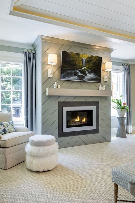 a neutral farmhouse living room with a built-in fireplace, a mantel and an artwork, some cozy vintage-inspired furniture