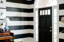 An entryway with a stripped wall