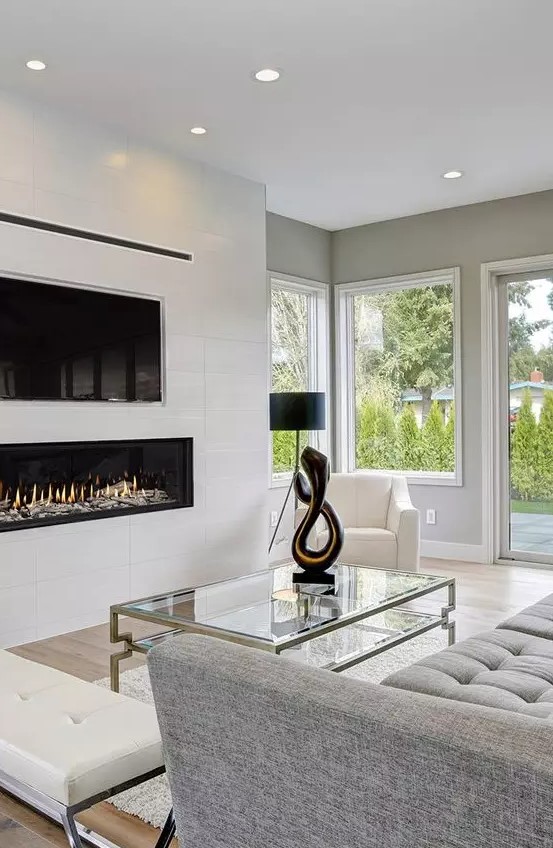 a white built in minimalist fireplace under the TV is a stylish and elegant idea that adds coziness