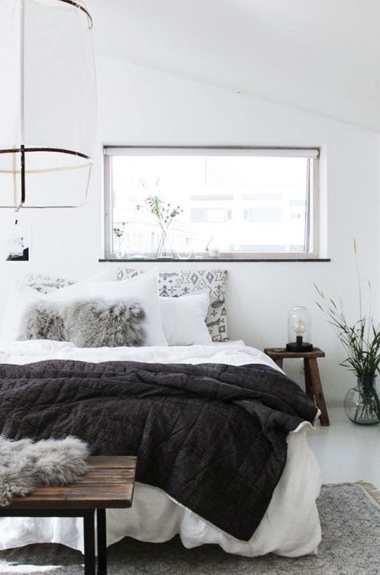 an airy bedroom done in white and accented with light greys can be spruced up with black touches anytime - just add a black blanket or bedding
