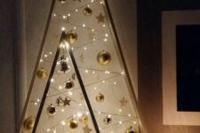 beautiful frame Christmas trees with gold ornaments, stars and lights are amazing to give a touch of shine and an eye-catchy look to your space