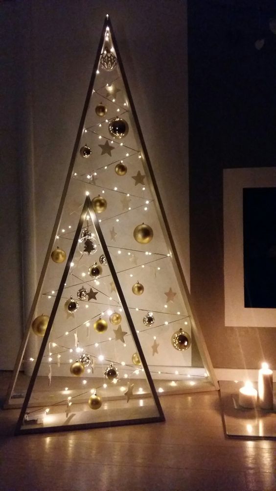 beautiful frame Christmas trees with gold ornaments, stars and lights are amazing to give a touch of shine and an eye-catchy look to your space