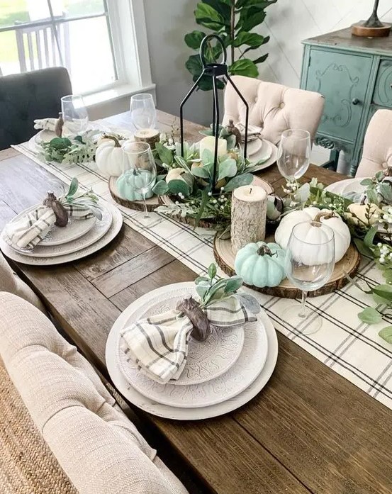 A cozy thanksgiving tablescape with a plaid runner