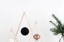 mini wood Christmas trees with ornaments like these ones will perfectly fit a minimalist interior and can be easily DIYed