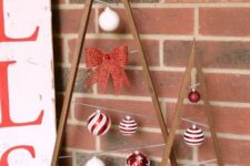 stained frames with red and white Christmas ornaments and bows are amazing to add a touch of color to the space