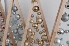 stained frames with silver and gold Christmas ornaments attached with glue look really magical and unusual