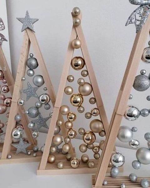 stained frames with silver and gold Christmas ornaments attached with glue look really magical and unusual