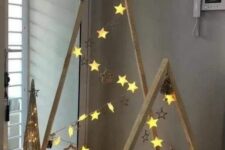 wood frame Christmas tree with star ornaments and star lights are a very simple and very cute idea of holiday decor