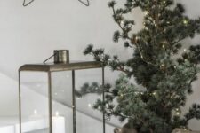 03 a Christmas tree in a basket covered with lights is a stylish idea for a Scandinavian or minimalist space