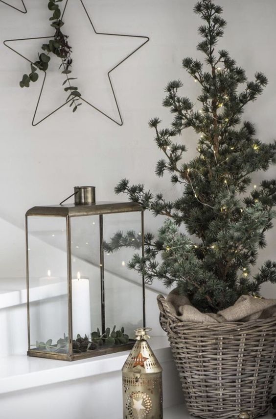 a Christmas tree in a basket covered with lights is a stylish idea for a Scandinavian or minimalist space