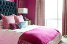 04 a magenta bedroom with a bed with a teal headboard, a chandelier, light pink curtains and a colorful rug is amazing