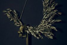 05 a minimalist Christmas wreath of a triangle shape,w ith olive branches and a green ribbon bow is a stylish idea