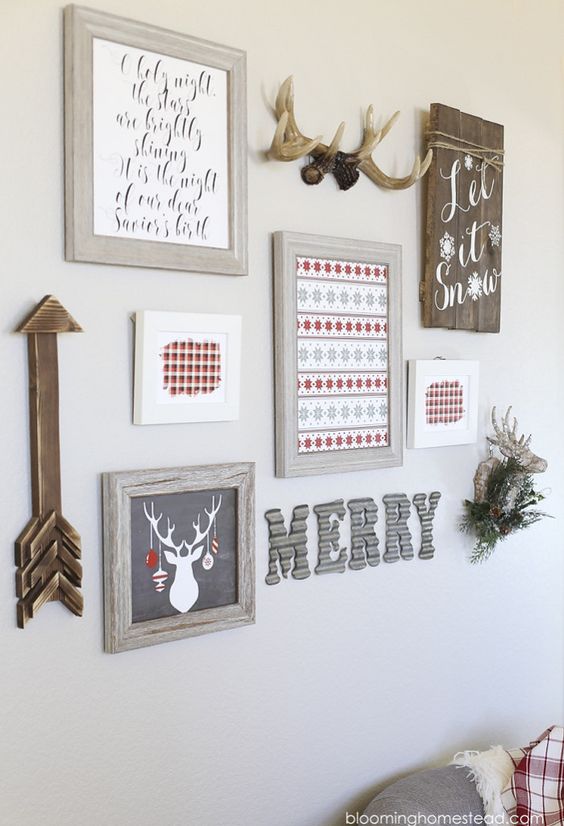 a cool Christmas gallery wall with various signs and rtworks, antlers, a wooden arrow and some letters is awesome