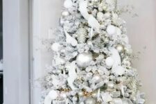 07 a dreamy flocked Christmas tree with silver and white ornaments, branches, ribbons and lights is an amazing idea