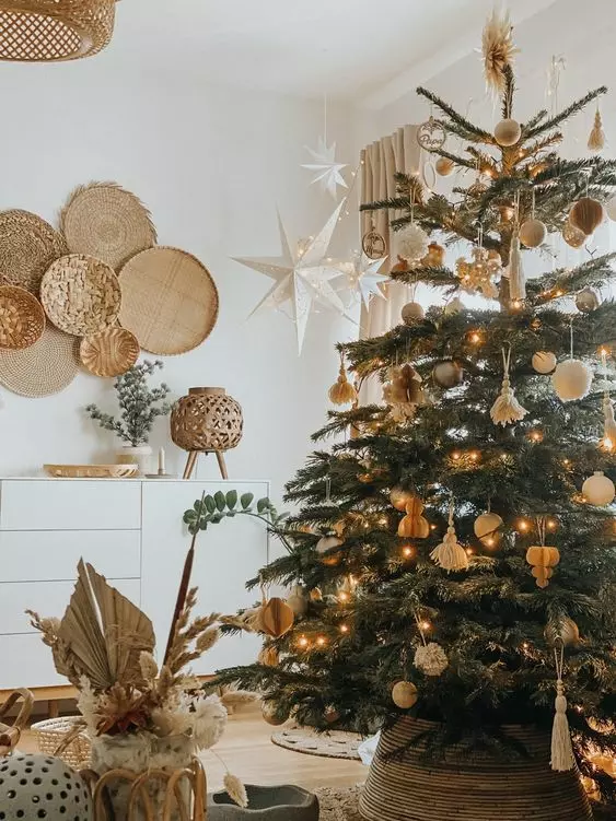 a boho Christmas tree with pompoms, paper ornaments, tassels and white ornaments plus lights