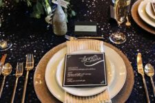 09 a dark sequin tablecloth, gold glitter chargers, gold cutlery and a lush greenery and bloom centerpiece