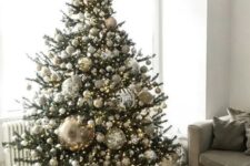 09 a jaw-dropping Christmas tree with silver, gold and glitter ornaments and oversized disco balls plus lights is ideal for party lovers